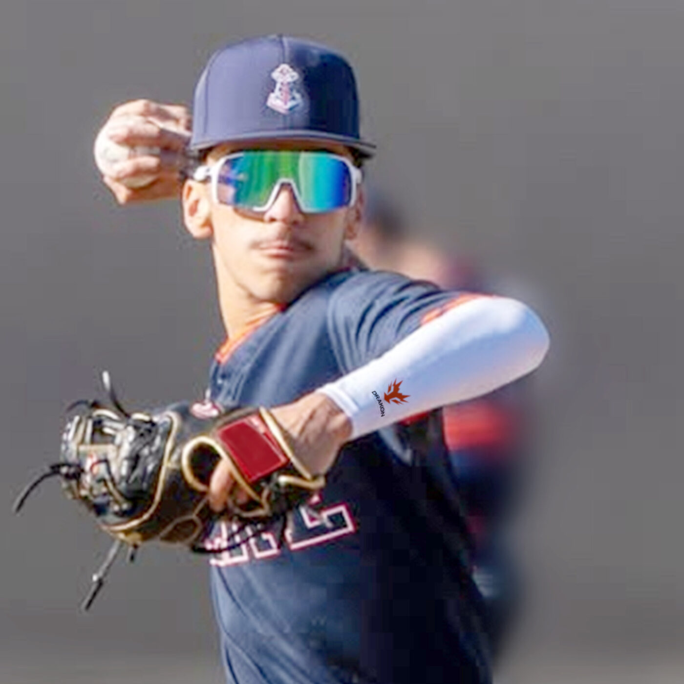 Drakon athlete mid-throw in a Drakon compression sleeve and sunglasses